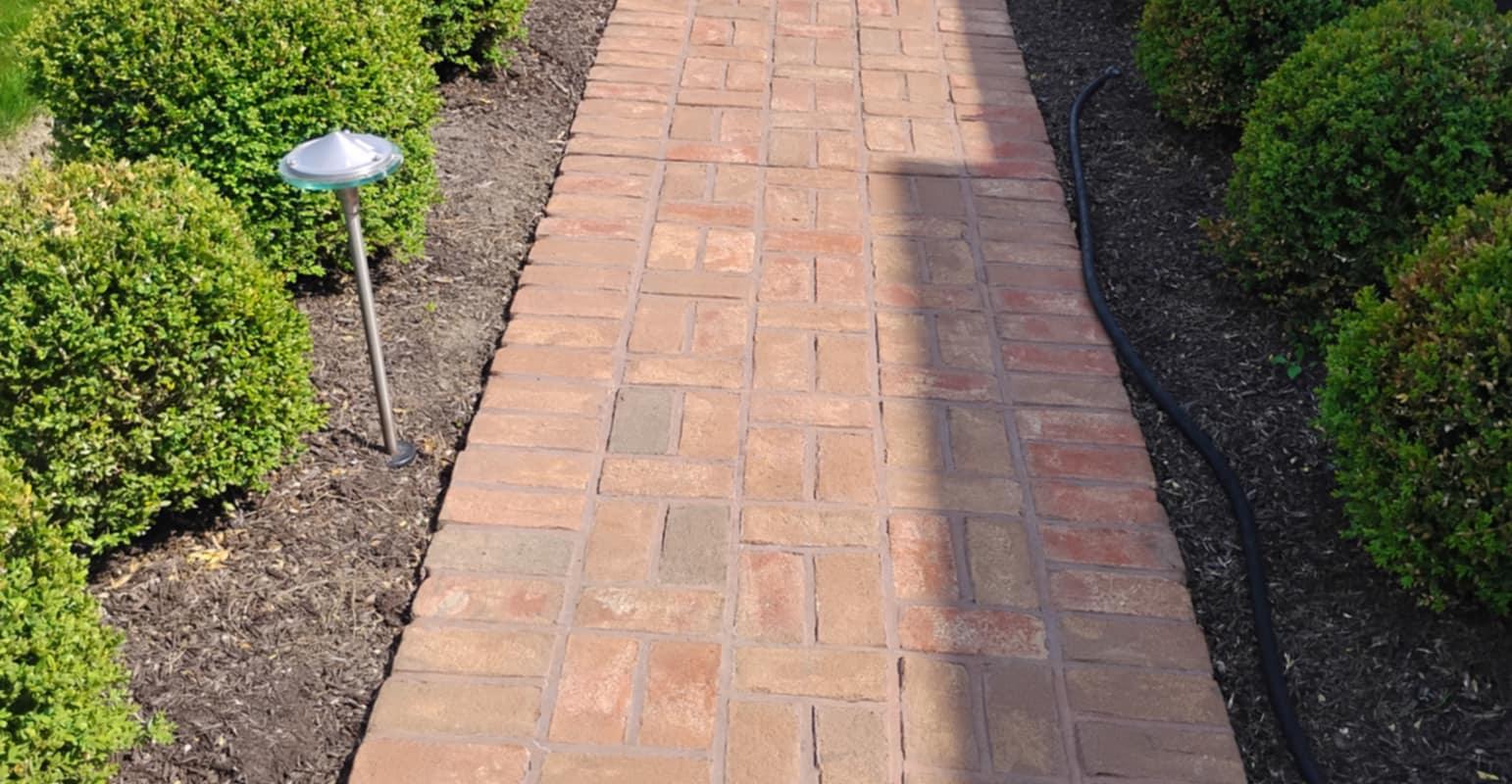 Beautiful brick paver walkway installed by Rhinesmith Masonry with expert craftsmanship